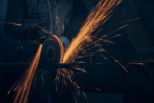 worker-polishing-metal-with-special-equipment-dark-room.jpg